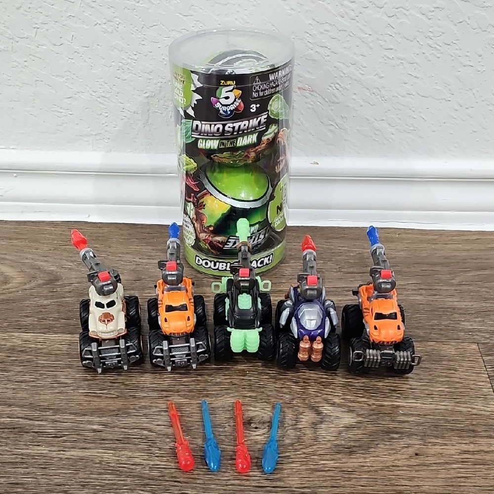 5 Surprise Bundle Of Dino Strike Glow In The Dark Double Pack And 5 Trucks